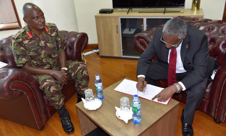 The University Of Nairobi Vice Chancellor Prof Stephene Kiama signing visitors book 